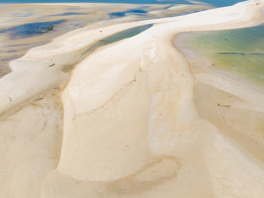 Aerial view of a white sand bars surrounded buy pools of blue water - Australian Stock Image