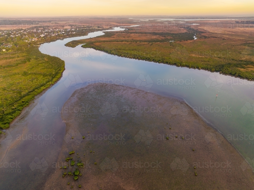 Aerial view of a wide calm river winding its way into the distance - Australian Stock Image