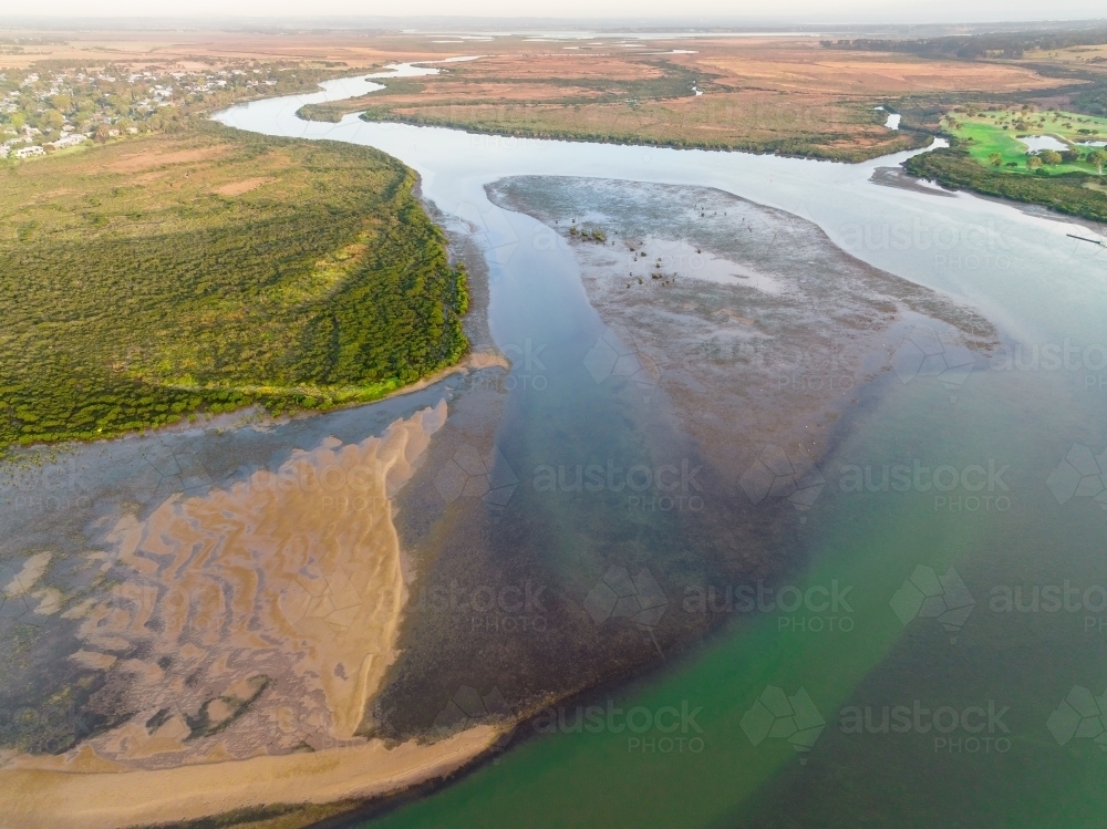 Aerial view of a wide calm river winding its way into the distance - Australian Stock Image