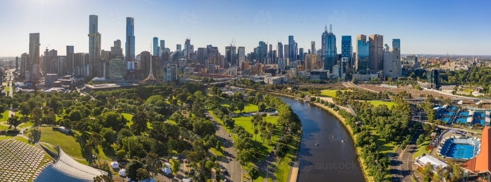 Image of Aerial view of a wide river winding towards a city with ...