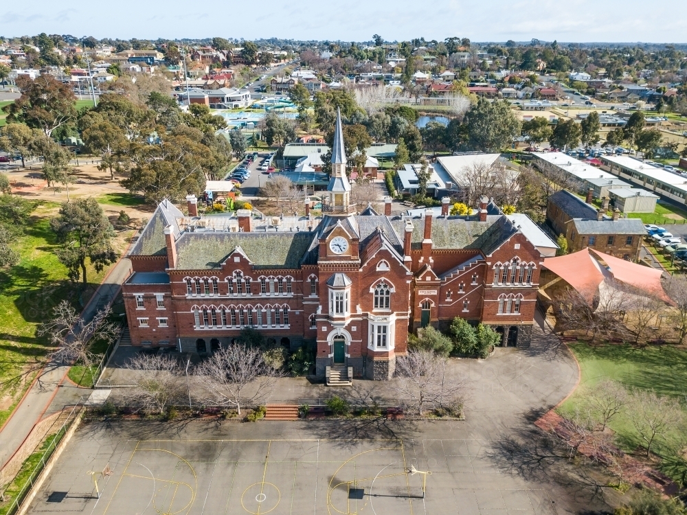 Aerial view of an historic school building with a tall clock tower - Australian Stock Image