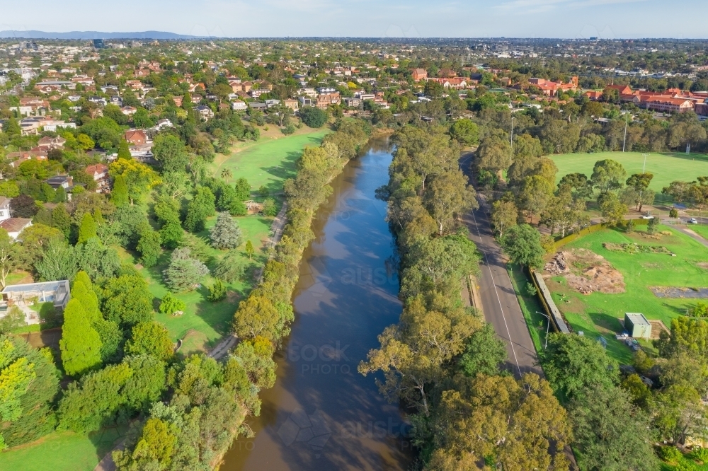 Aerial view of an inner city river with green parkland either side - Australian Stock Image