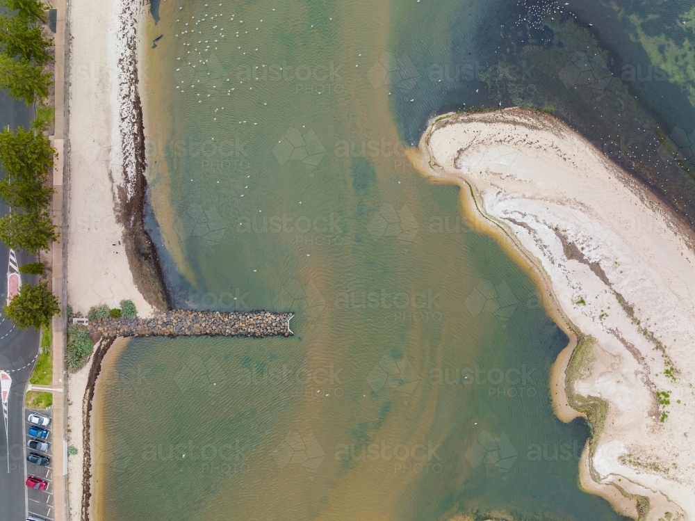 Aerial view of an unusually shaped sand bar near a breakwater on the coast - Australian Stock Image