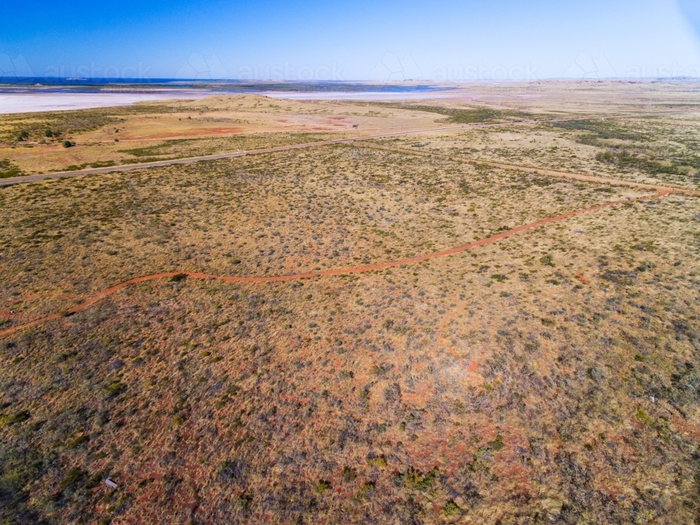 aerial view of arid country towards the sea - Australian Stock Image