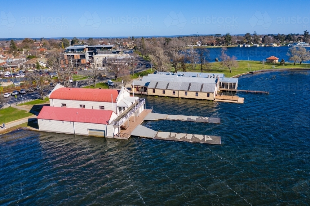 Aerial view of boat sheds along the shores of a lake - Australian Stock Image