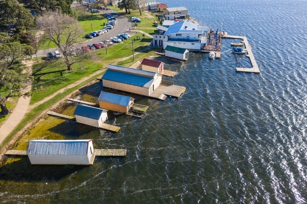 Aerial view of boat sheds along the shores of a lake - Australian Stock Image