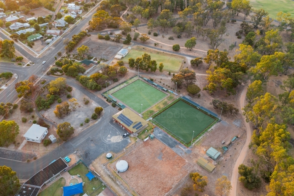 Aerial view of bowling greens and a recreation area on the edge of a rural town - Australian Stock Image