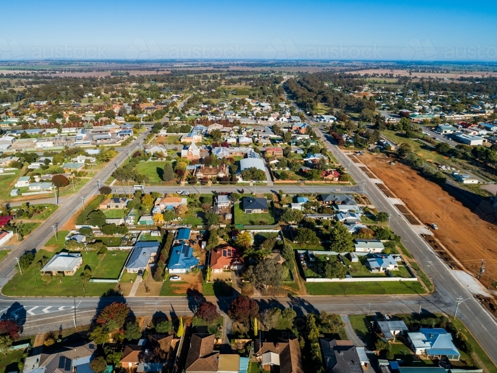 Aerial view of bright morning sunlight shining on rooves of houses in Riverina area country town - Australian Stock Image