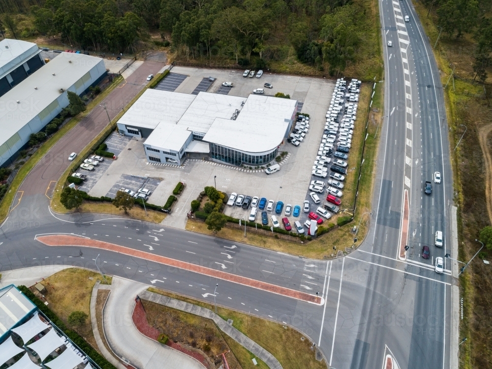 Aerial view of car dealership and intersection on highway - Australian Stock Image