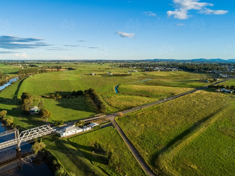 Aerial view of Clarence Town Road and timber truss bridge in green landscape - Australian Stock Image