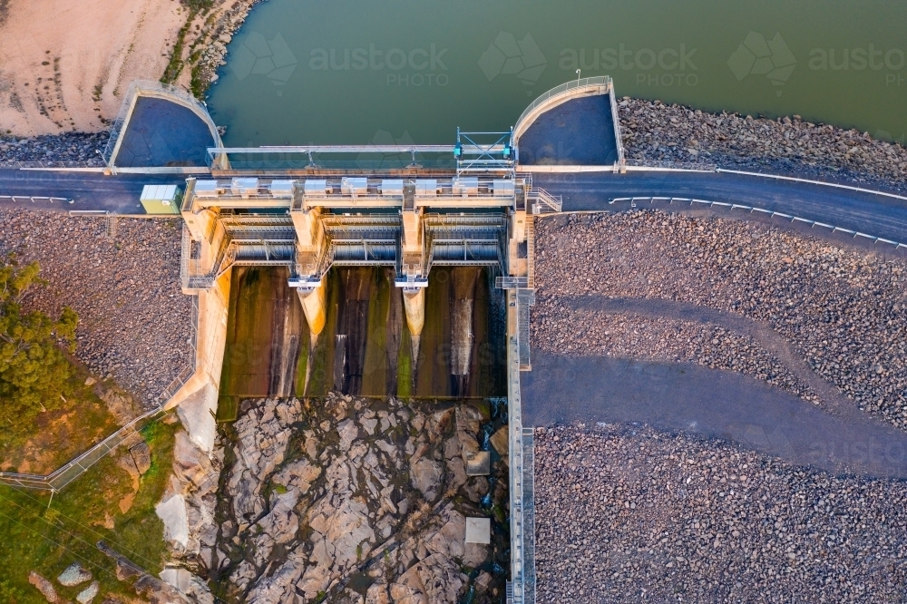 Aerial view of closed flood gates in a dam wall - Australian Stock Image