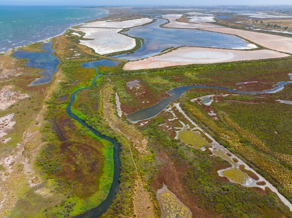 Aerial view of coastal wetlands with colourful vegetation and dry salt lakes - Australian Stock Image