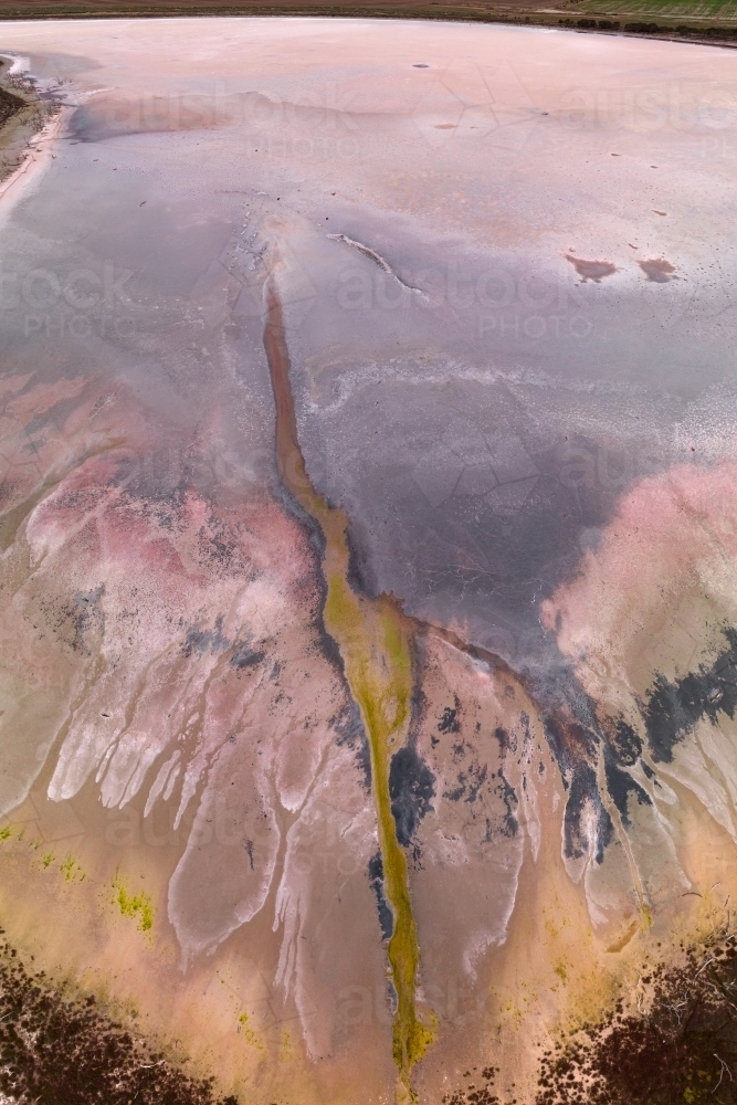 Aerial view of colourful patterns and textures in a dry salt lake - Australian Stock Image