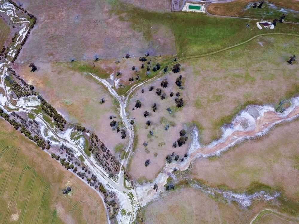 Aerial view of creek with trees and fences - Australian Stock Image