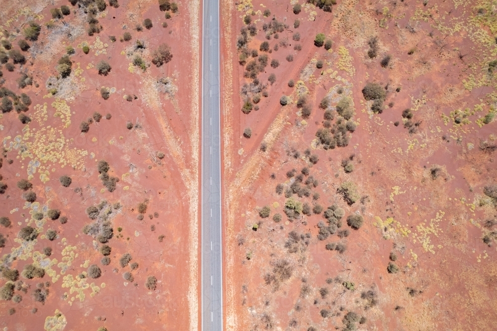 Aerial view of desert road with surrounding shrubbery - Australian Stock Image