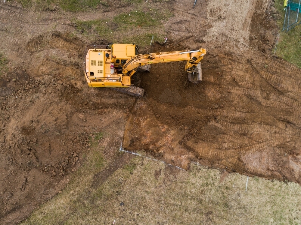 Aerial view of digger on house build construction site - Australian Stock Image
