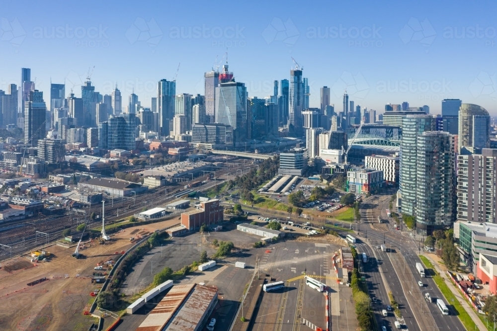 Aerial view of factories and vacant land in front of high rise buildings of a city - Australian Stock Image