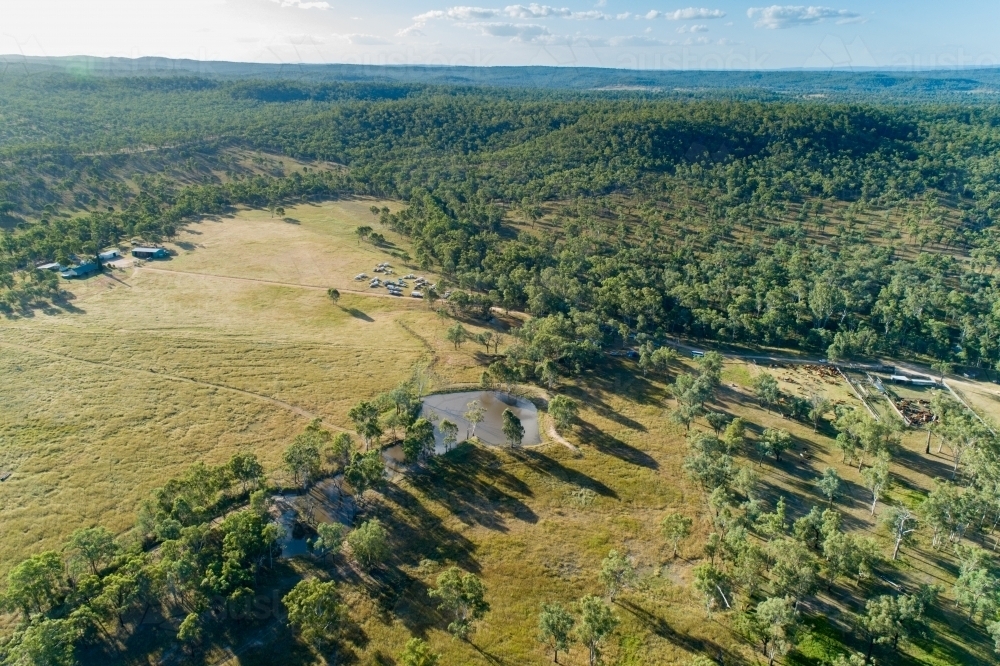 Aerial view of farm homestead, dam, and cattle yards. - Australian Stock Image