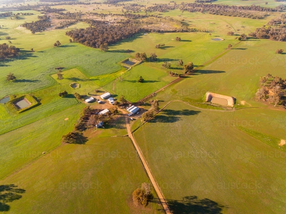 aerial view of farm in springtime with green crops and pastures - Australian Stock Image