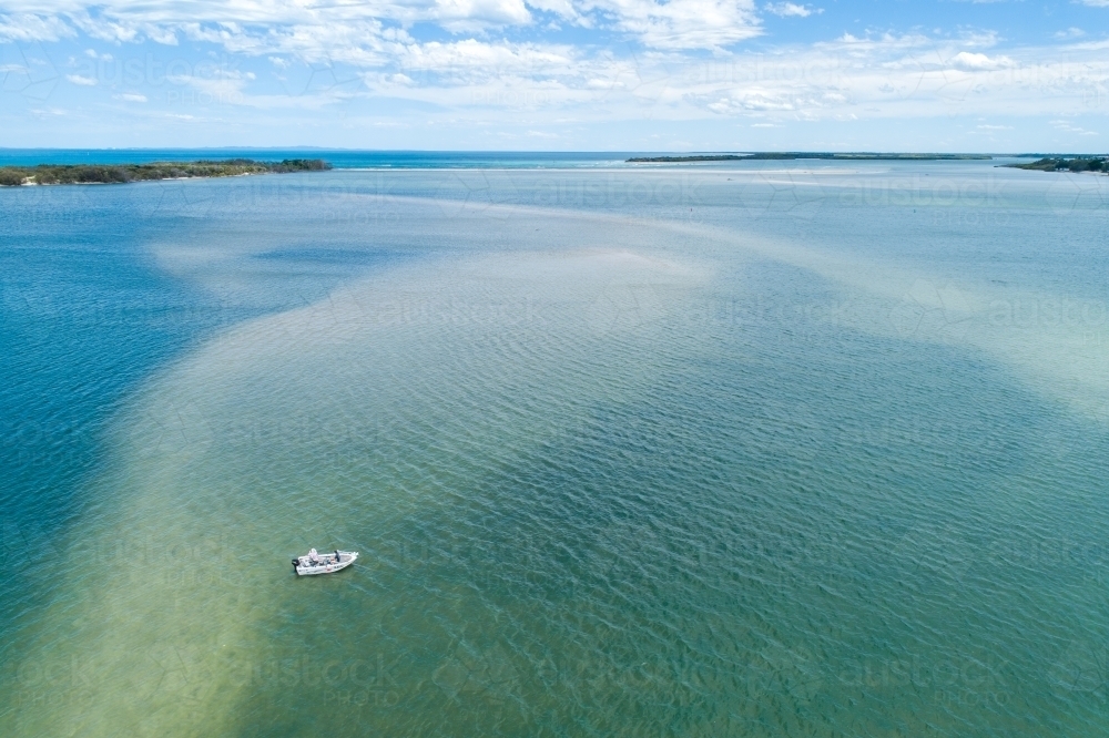 Aerial view of fishing boat on Pumicestone Passage in front of Bribie Island, Queensland. - Australian Stock Image