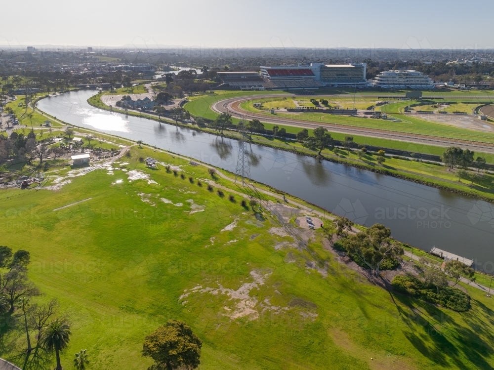 Aerial view of green parkland and racecourse alongside an inner city river - Australian Stock Image