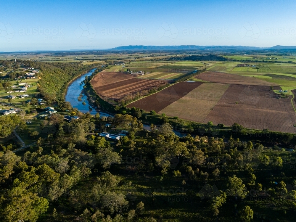 Aerial view of houses overlooking hunter river and farmland below - Australian Stock Image