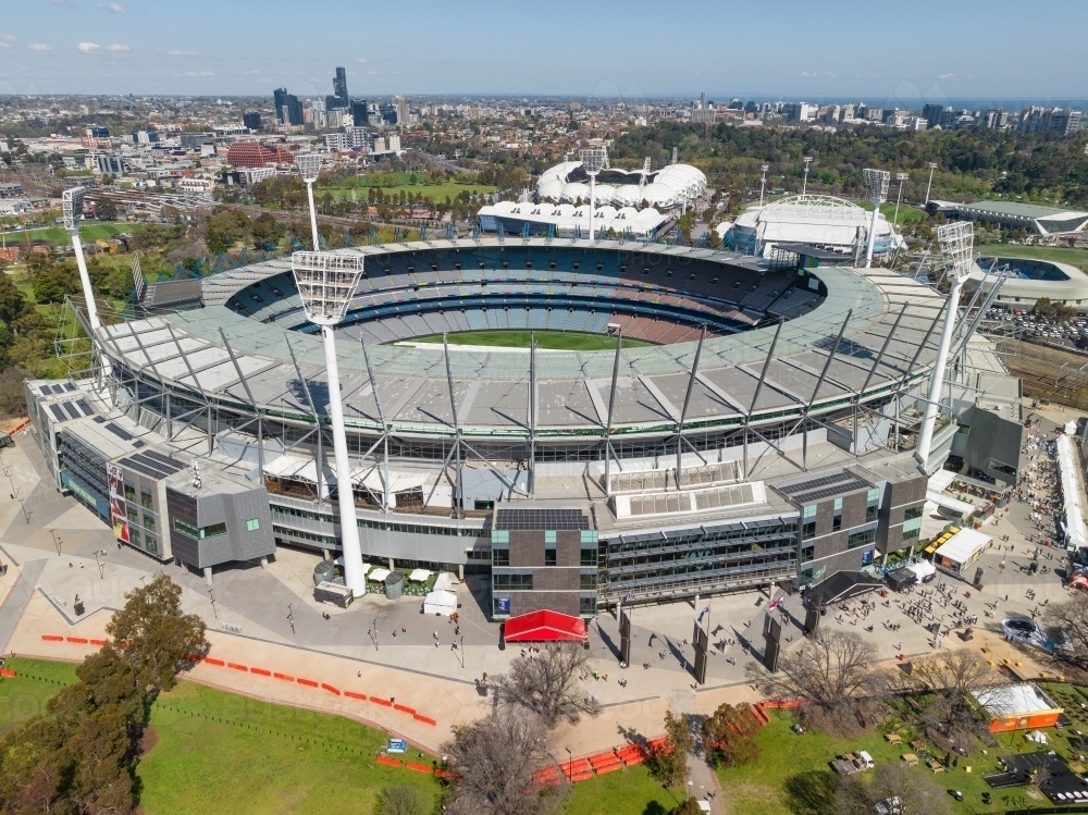 Aerial view of large inner city sporting arena with tall light towers in East Melbourne - Australian Stock Image