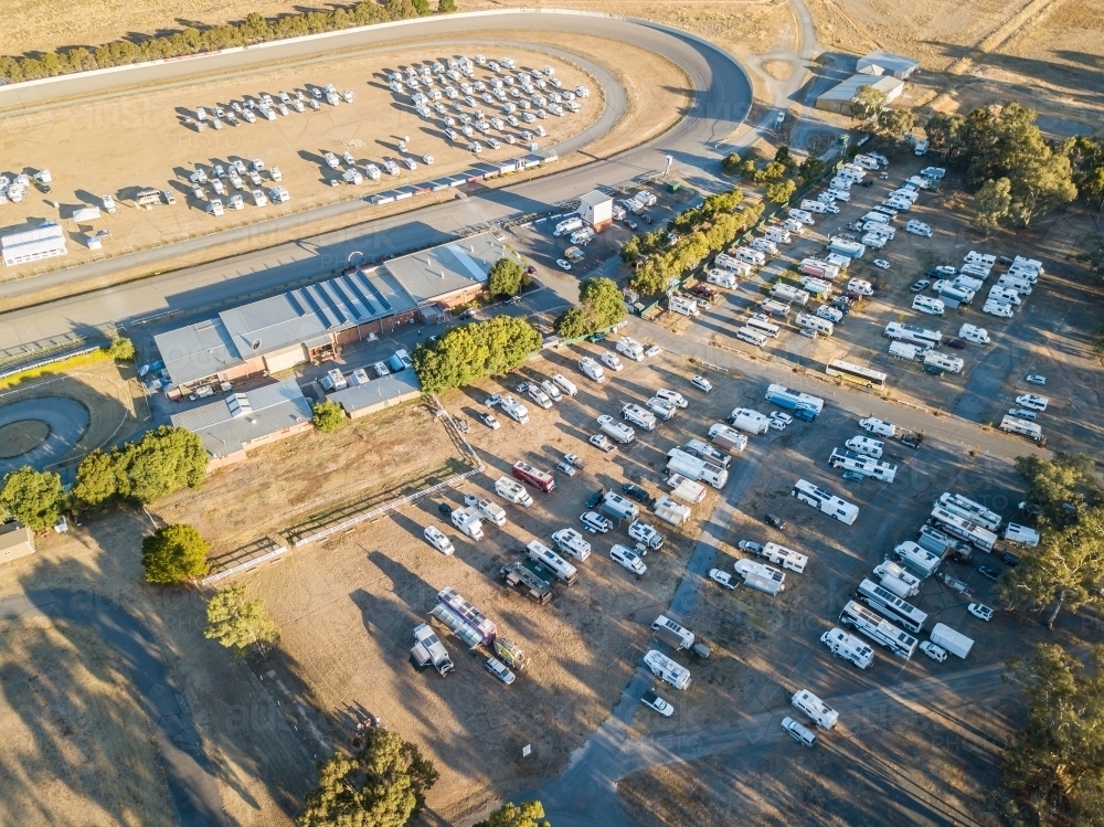 Aerial view of lots of motorhomes parked on rows on a reserve - Australian Stock Image