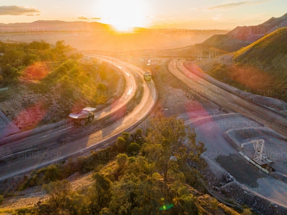 Aerial view of mining dump truck machinery collecting coal in open cut mine - Australian Stock Image