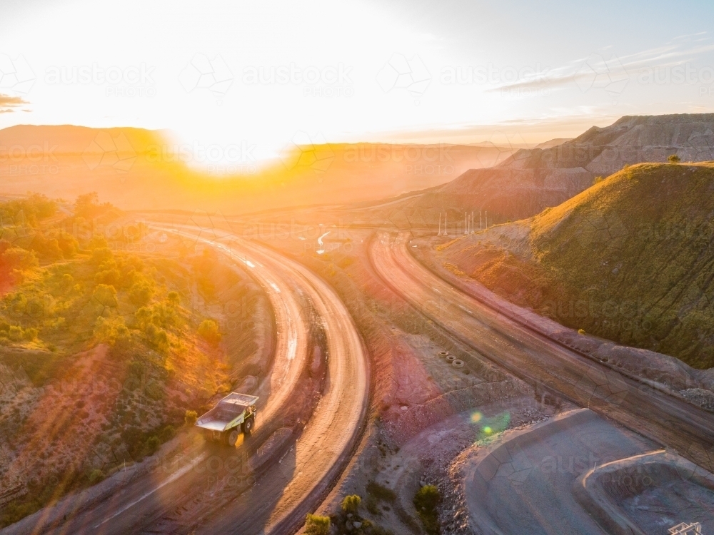 Aerial view of mining dump truck machinery collecting coal in open cut mine - Australian Stock Image