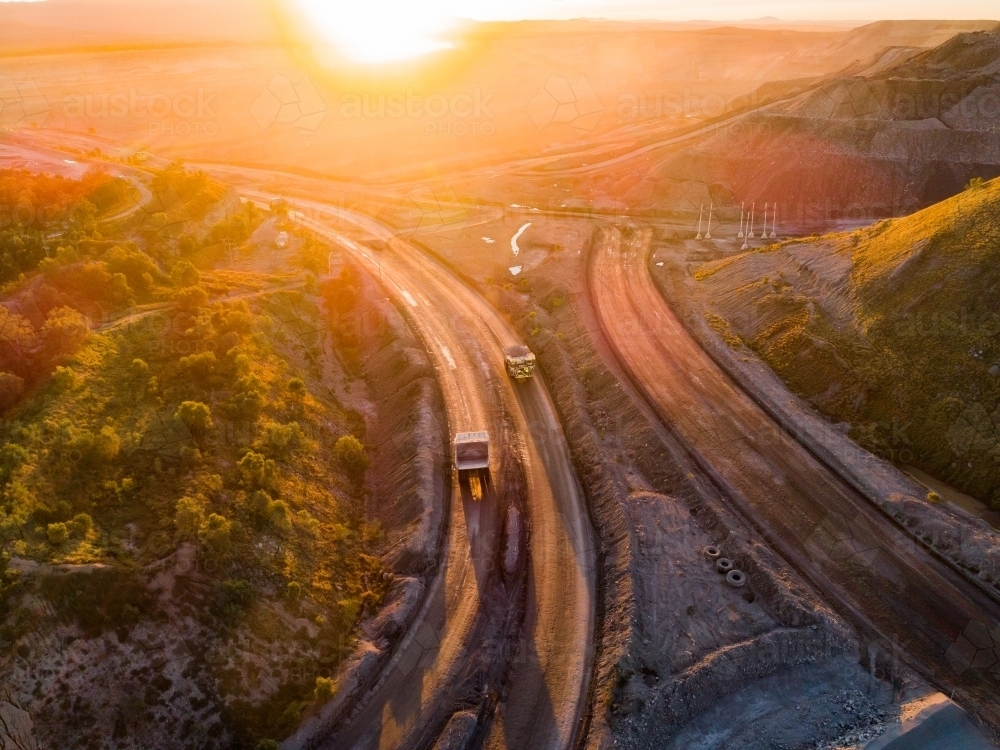 Aerial view of mining dump truck machinery collecting coal in open cut mine - Australian Stock Image