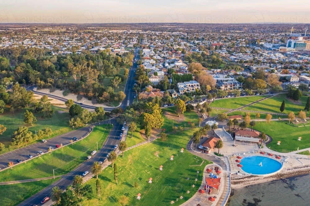 Aerial view of parkland and swimming pool along a coastal waterfront - Australian Stock Image