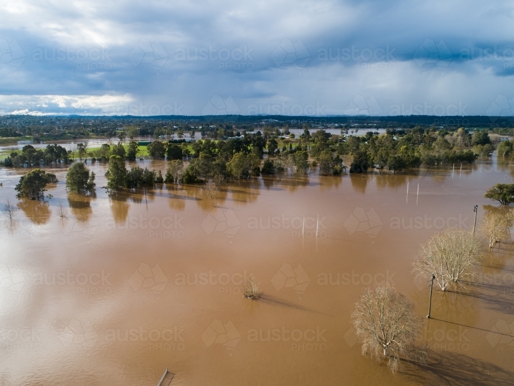 Image of Aerial view of playing field underwater during flood in ...