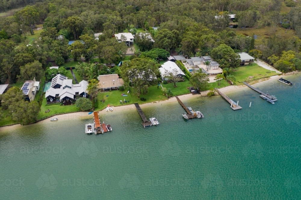 Aerial view of riverfront properties with private jetties - Australian Stock Image