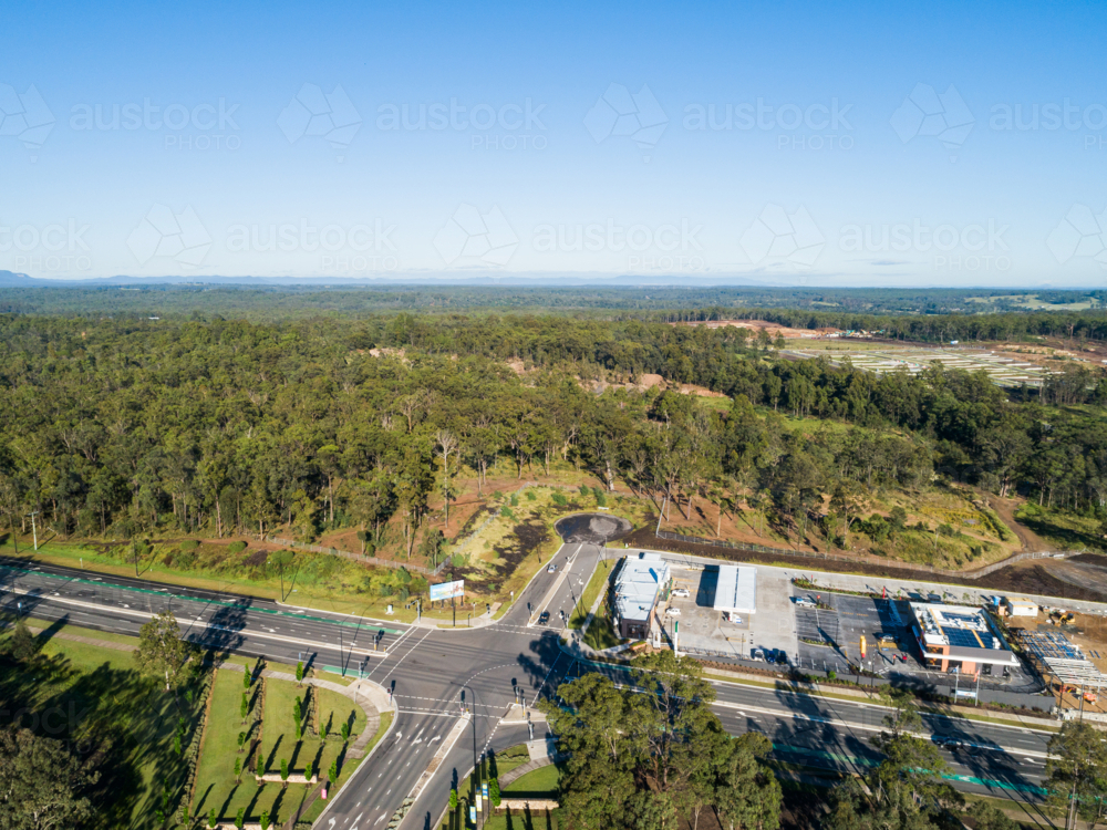 Aerial view of road in Huntlee with new fast food and petrol station development on roadside - Australian Stock Image