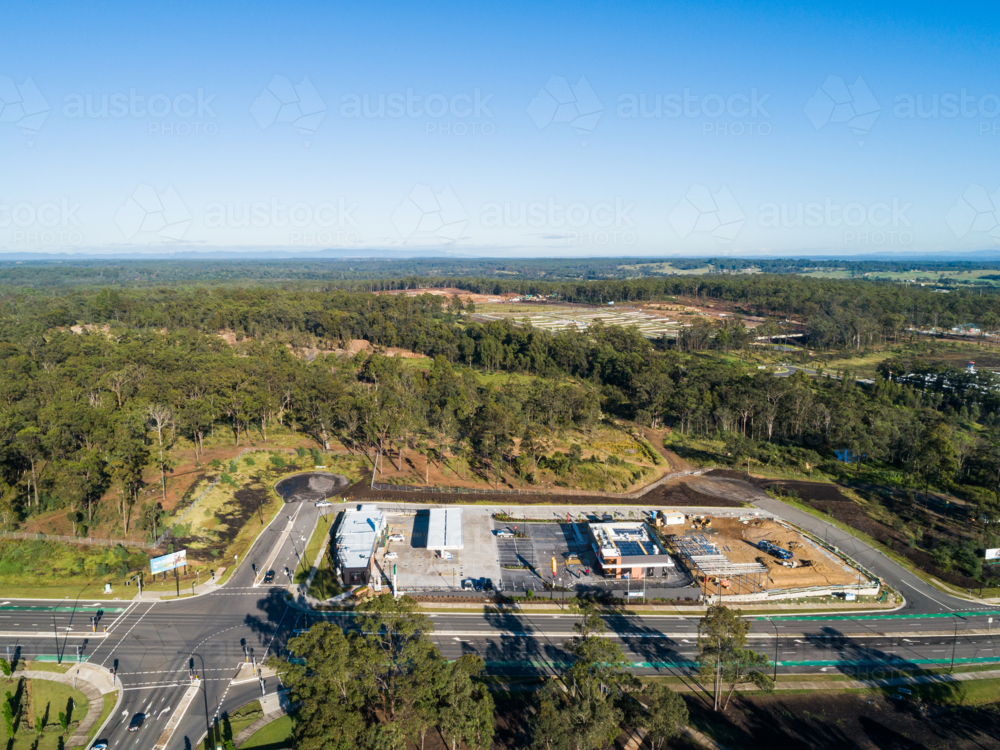 Aerial view of road in Huntlee with new fast food and petrol station development on roadside - Australian Stock Image