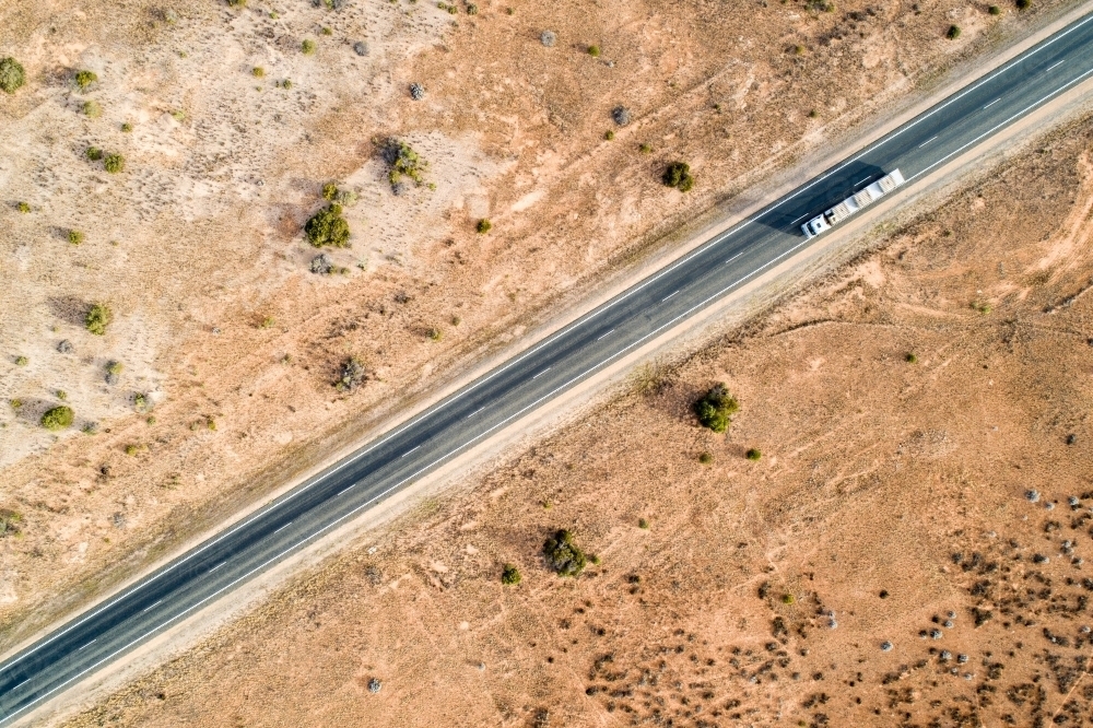 Aerial view of road train truck on Eyre Highway along the Nullarbor Plain - Australian Stock Image