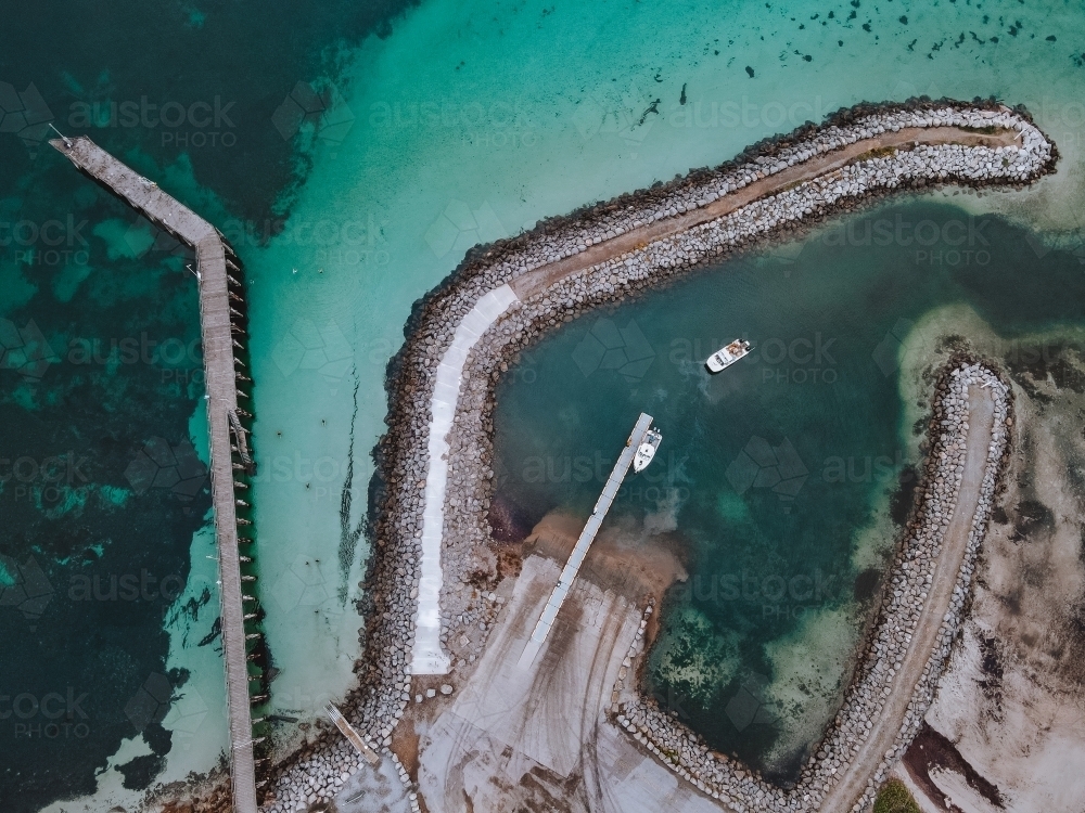 Aerial view of rock pier on coastline - Australian Stock Image