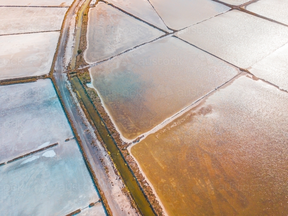 Aerial view of salt evaporation ponds of various shapes - Australian Stock Image