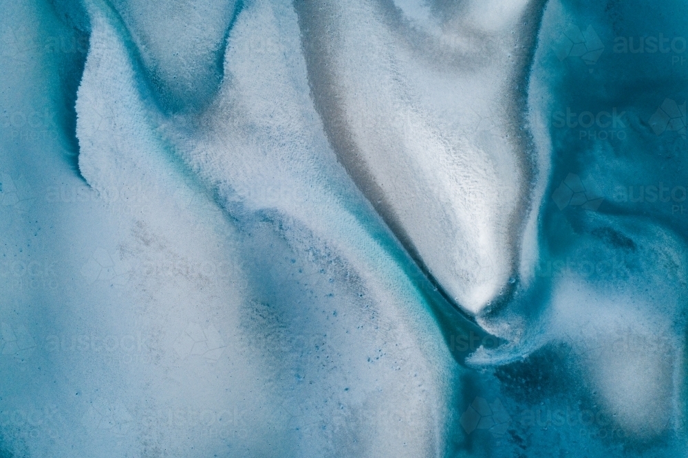 Aerial view of sandbar patterns in shallow blue water. - Australian Stock Image