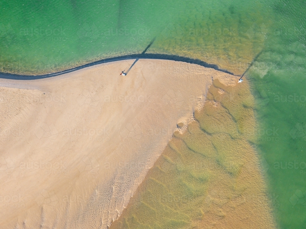 Aerial view of sandbars and waves at the mouth of a tidal river - Australian Stock Image