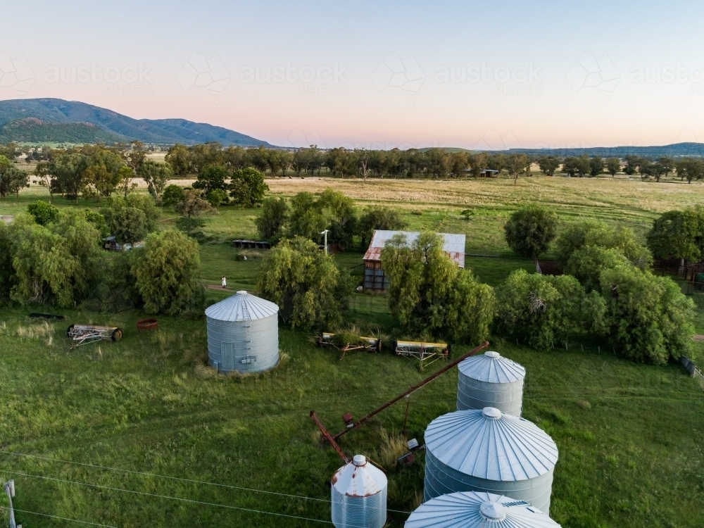 Aerial view of silos on farm at dusk - Australian Stock Image