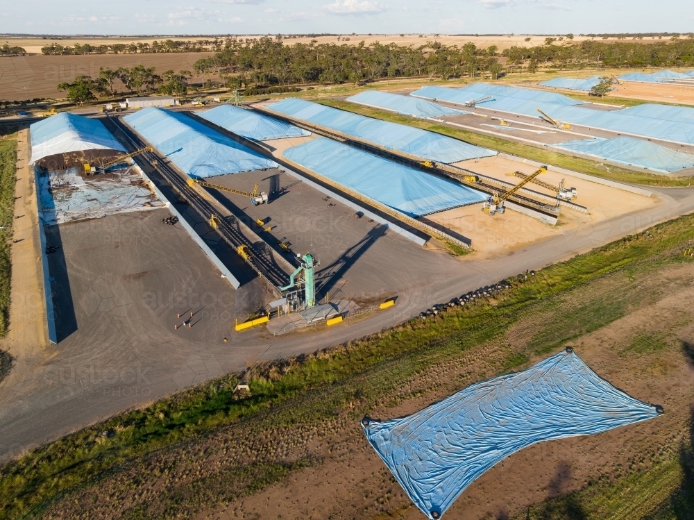 Aerial view of tarpaulins covering grain storage pits in a rural setting - Australian Stock Image