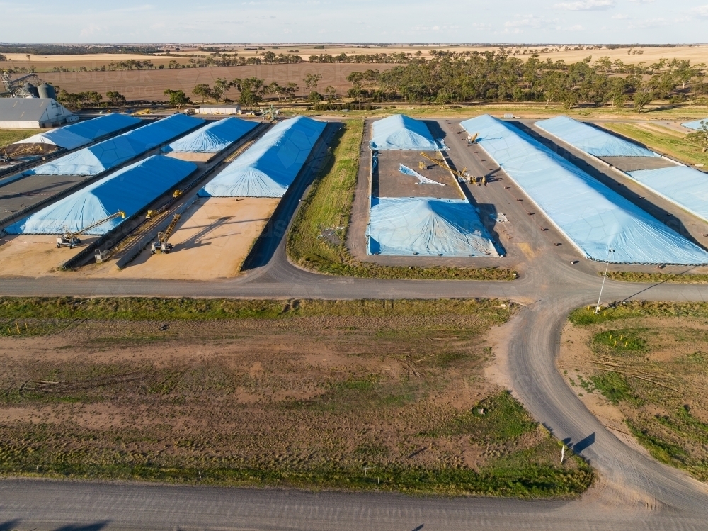 Aerial view of tarpaulins covering grain storage pits in a rural setting - Australian Stock Image