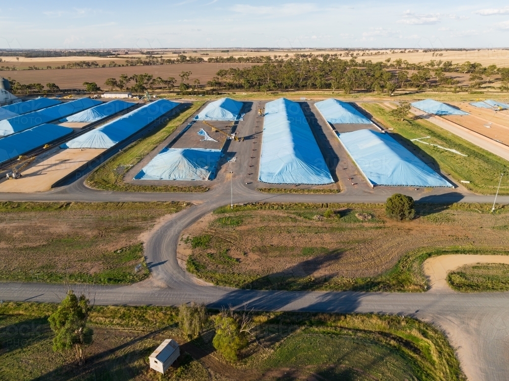 Aerial view of tarpaulins covering grain storage pits in a rural setting - Australian Stock Image