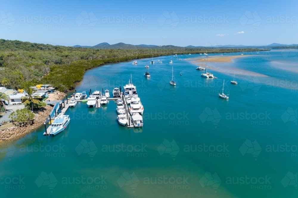 Aerial view of the 1770 Marina and yachts anchored in the estuary, Town of 1770, QLD. - Australian Stock Image