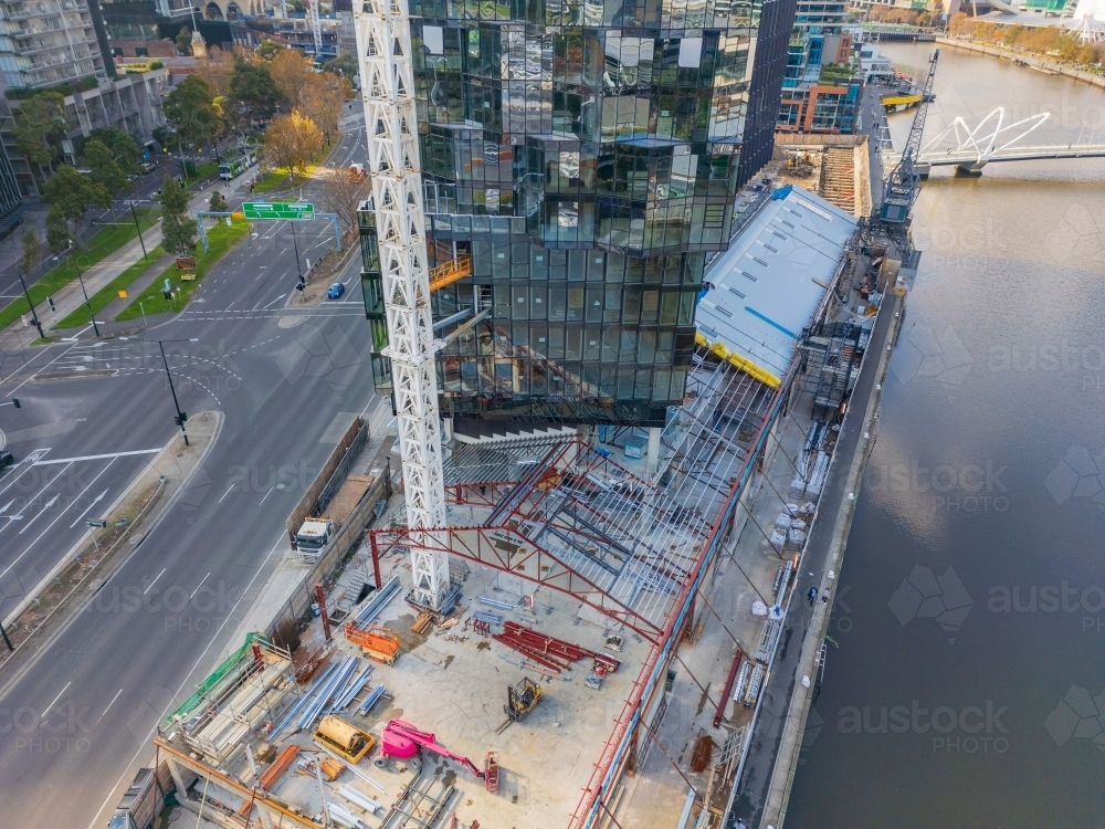 Aerial view of the base of a large crane on an inner city construction site - Australian Stock Image
