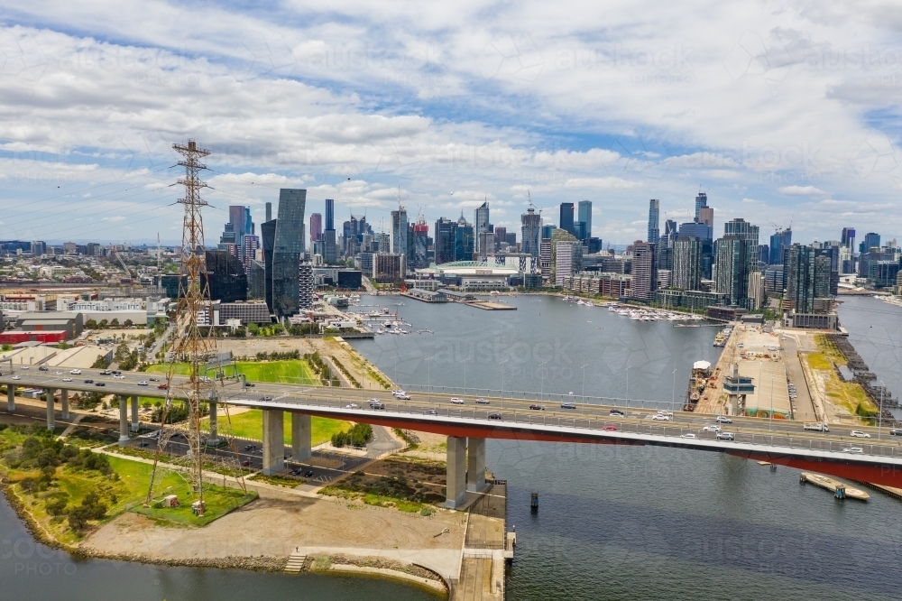 Aerial view of the Bolte Bridge over the Yarra River and Melbourne city skyline in the background - Australian Stock Image