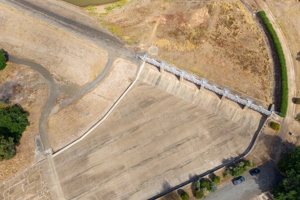 Aerial view of the dry concrete spillway of a reservoir - Australian Stock Image