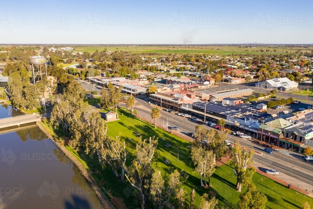 Aerial view of the main street of a regional town next to a river and parkland - Australian Stock Image